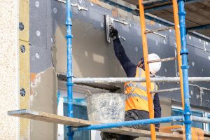 A contractor carrying out external wall insulation retrofit