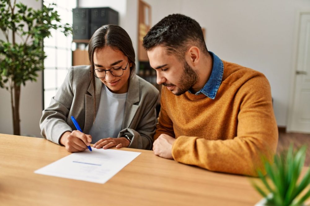 Man and woman signing a document