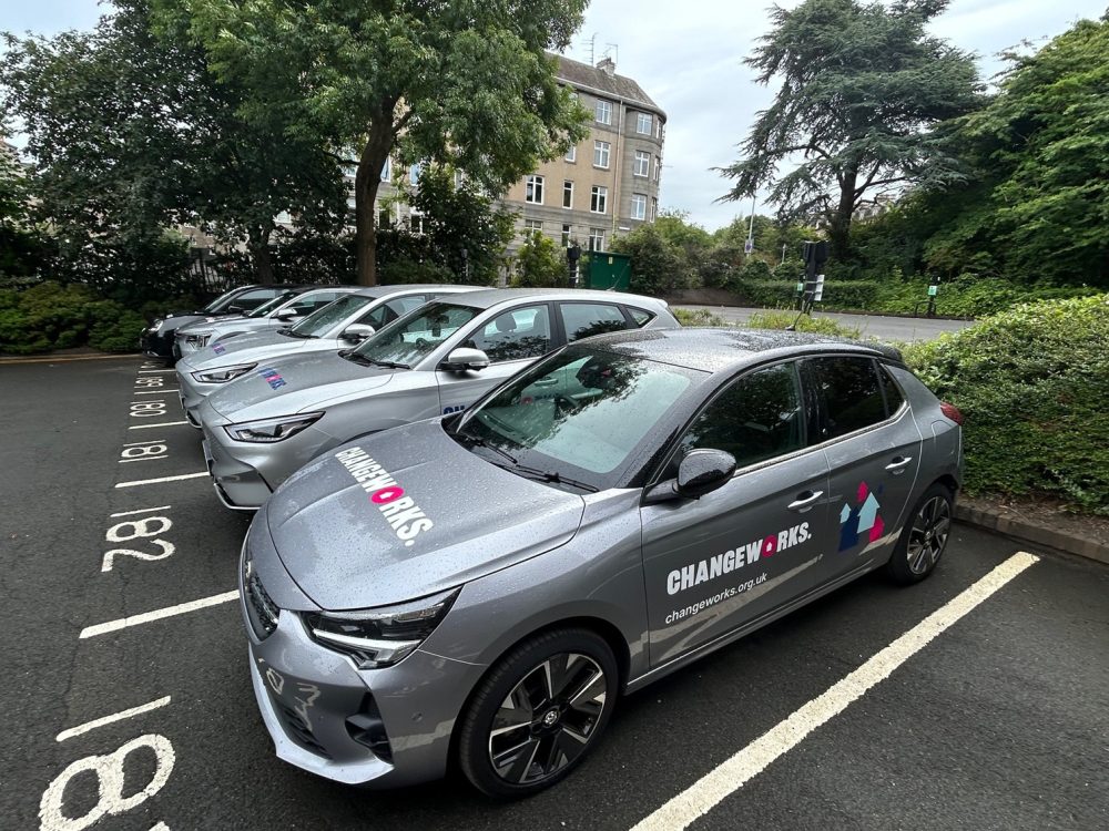 5 Changeworks' branded electric vehicles in a car park