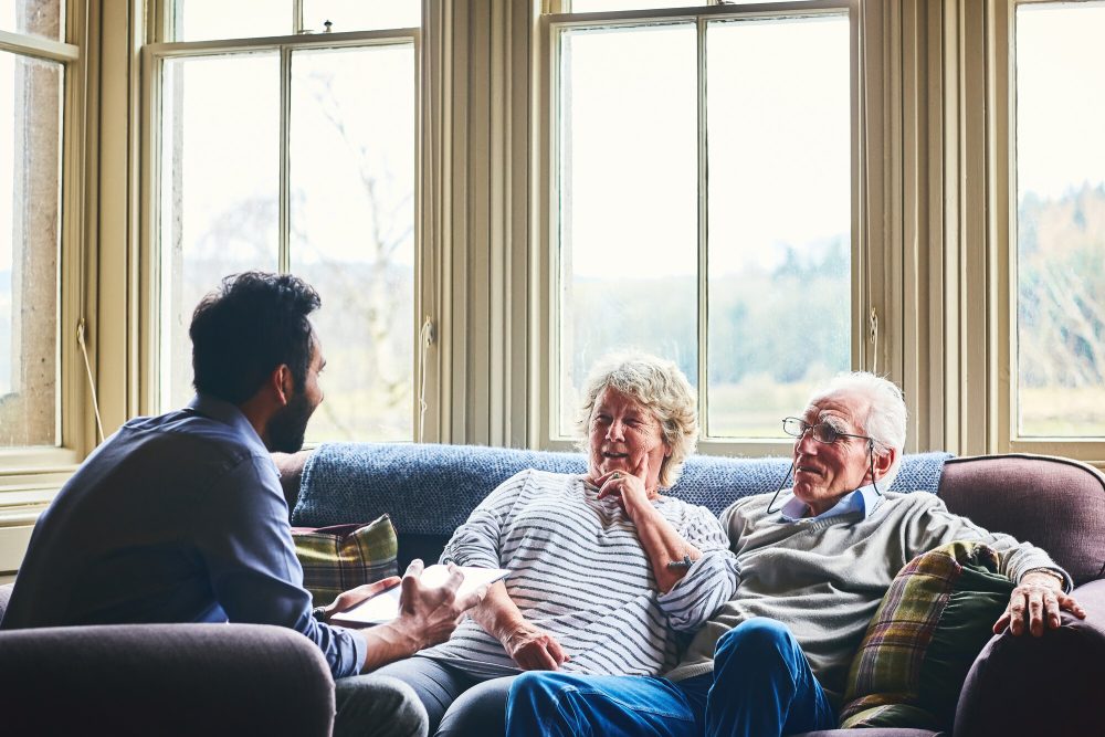 Younger man supporting older couple as their third party